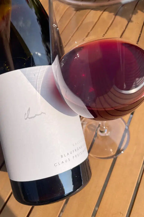 Claus Preisinger Blaufränkisch Kalkstein 2023 bottle and glass - Natural Wine Dealers