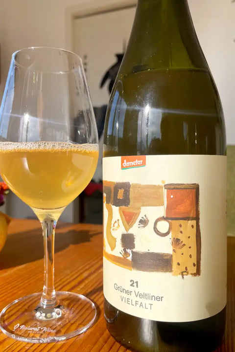 Bottle and glass of Hager Matthias Grüner Veltliner Vielfalt 2021 - Natural Wine Dealers