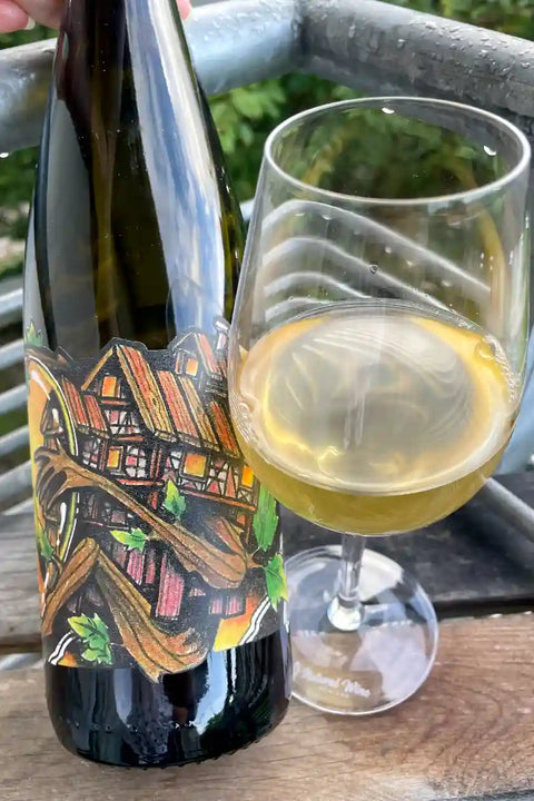 Bottle and glass of Domaine Muller Koeberle Riesling Burgreben 2023 - Natural Wine Dealers