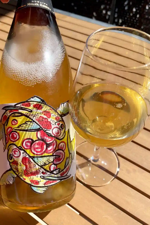 Bottle and glass of Domaine Muller Koeberle Hugo Cremant 2020 - Natural Wine Dealers