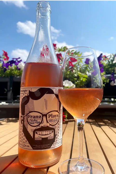 Bottle and glass of Weninger Franz Plays - Natural Wine Dealers