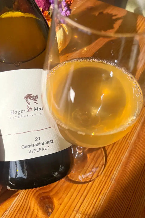 Bottle and glass of Hager Matthias Gemischter Satz 2021 - Natural Wine Dealers