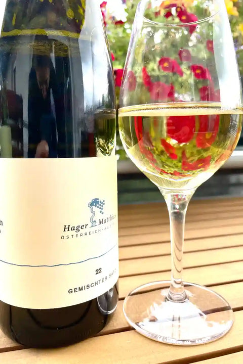 Bottle and glass of Hager Matthias Gemischter Satz 2022  - Natural Wine Dealers