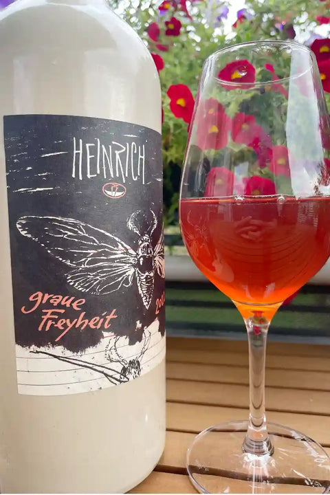 Ceramic bottle and a glass of Heinrich Graue Freyheit 2022 - Natural Wine Dealers