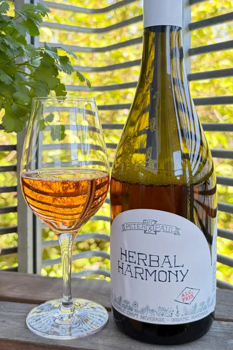 Bottle and glass of Herbal Harmony non-alcoholic beverage with a white label - Natural Wine Dealers