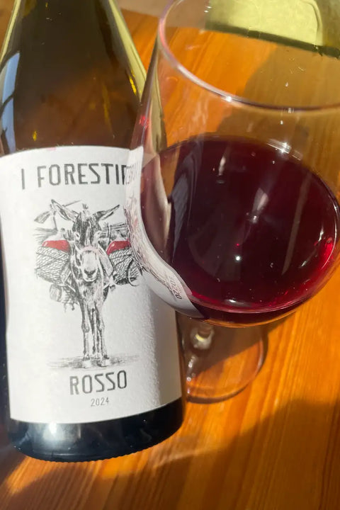Bottle and glass of I Forestieri Rosso 2024 - Natural Wine Dealers