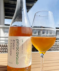 Bottle and glass of Petracavallo Bianco d'Alessano 2023- Natural Wine Dealers
