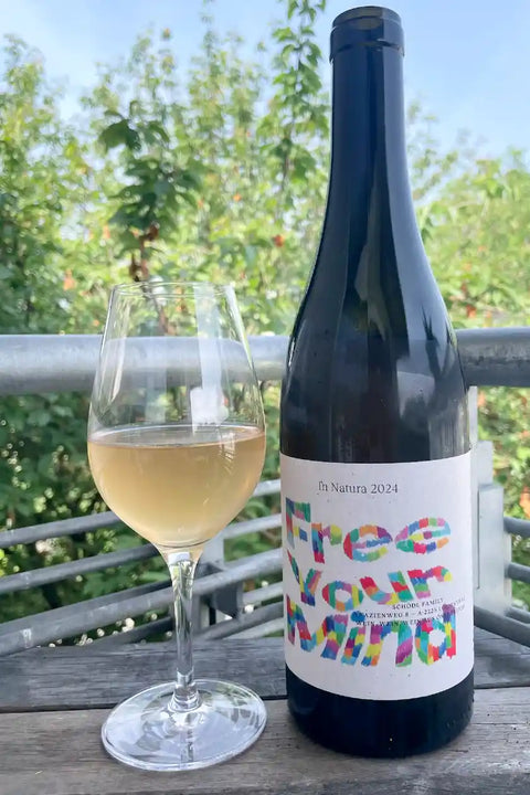 Bottle and glass of Weingut Schoedl Free your Mind 2024 - Natural Wine Dealers